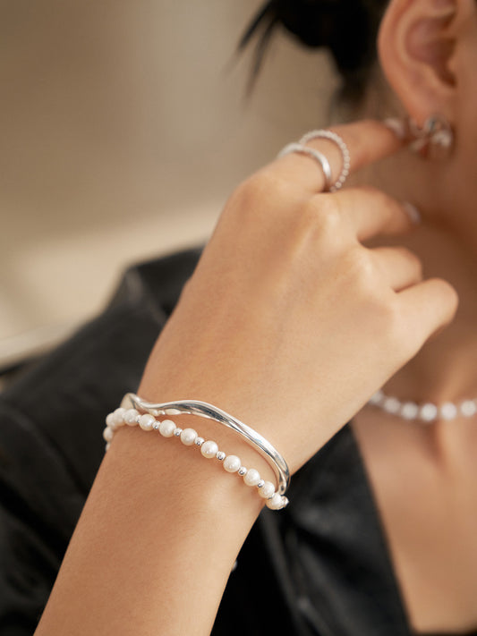a pearl bracelet with a Mobius bangle
